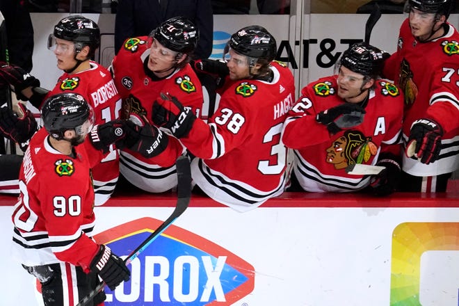 Blackhawks center Tyler Johnson (90) celebrates with teammates after scoring a goal against the Red Wings during the first period.