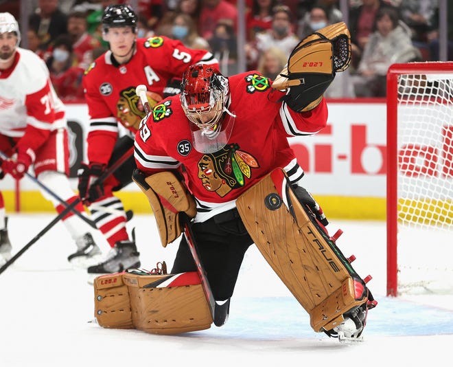 Blackhawks goalie Marc-Andre Fleury makes a save off of his leg pad against the Red Wings.