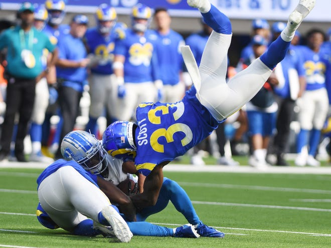 Lions Khalif Raymond is brought down by Rams' Nick Scott after a reception in the second quarter.
