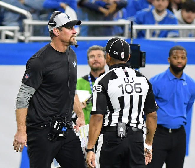 Lions head coach Dan Campbell talks with officials after a Lions penalty for calling back-to-back timeouts in the fourth quarter.