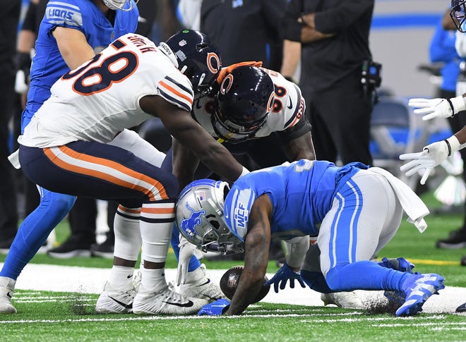 Lions running back D'Andre Swift loses the ball and Chicago recovers in the first quarter. After review, the Bears player stepped out of bounds, and Detroit retained possession.