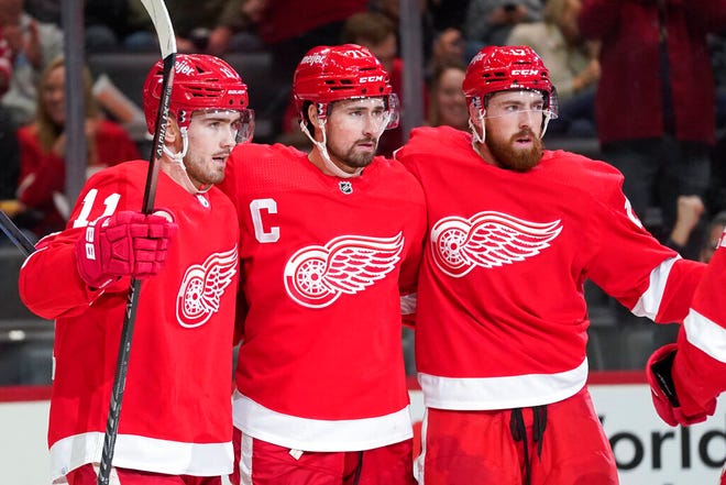 Detroit Red Wings center Dylan Larkin, center, celebrates his goal with Filip Zadina, left, and Filip Hronek in the second period of Wednesday's game in Detroit.