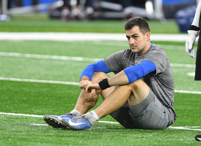 Lions backup quarterback David Blough sits on the field during warm-ups at Ford Field.