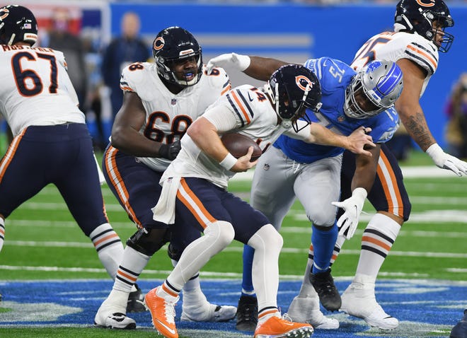 Bears quarterback Andy Dalton is sacked by Lions' Levi Orwuzurike in the fourth quarter.