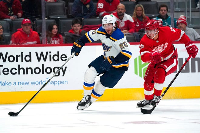 St. Louis Blues left wing Brandon Saad (20) protects the puck from Detroit Red Wings defenseman Gustav Lindstrom (28) in the first period of Wednesday's game in Detroit.