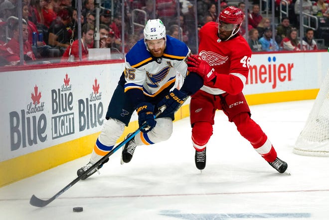 St. Louis Blues defenseman Colton Parayko (55) protects the puck from Detroit Red Wings right wing Givani Smith (48) in the second period of Wednesday's game in Detroit.