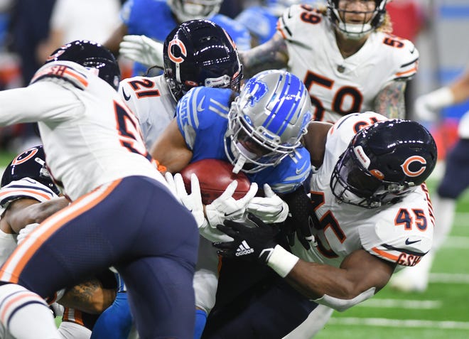 Chicago's defense swarms Lions wide receiver Kalif Raymond after a reception in the first quarter.