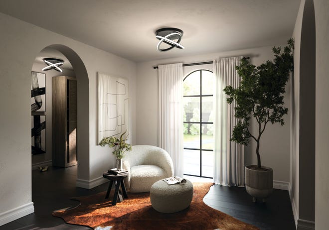 Flush mount fixtures with modern forms accentuate a ceiling. These intersecting rings that suggest celestial shapes illuminate a room.