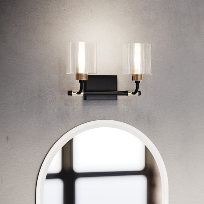 Wall sconces have been a popular option for homes where they add function and form to any space. They can brighten a bathroom like this two-light style that delivers visual interest above a vanity mirror.