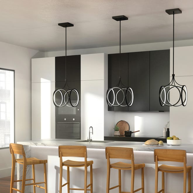 A series of LED pendants lends an elegant touch above a kitchen island. Black fixtures as well as decorative styles with integrated LED lights have been trending.