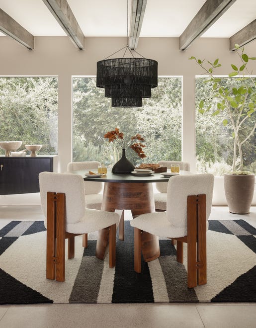 Natural materials are appearing in the latest light fixtures like this black jute pendant that makes a statement above a dining table.