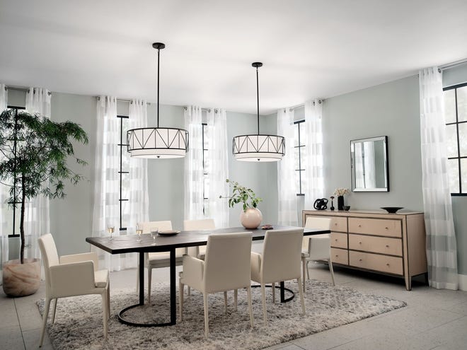 A pair of pendants highlights a dining table. The black details and geometric pattern add personality to the decorative fixtures.