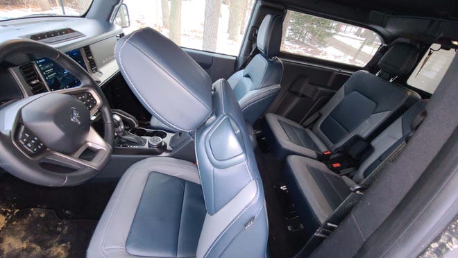 The 2021 Ford Bronco 2-door makes rear seat access easy with a seat pull tab.