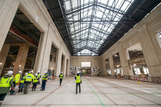 Journalists tour the atrium as construction continues at the Michigan Central Station, owned by Ford, in Detroit, January 11, 2022.