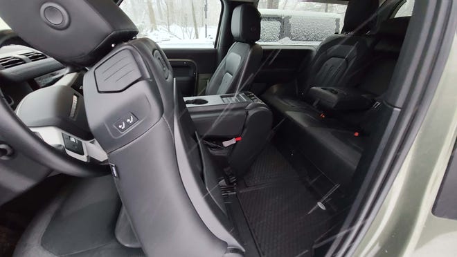 The rear seats of the 2021 Land Rover Defender 90 can be easily accessed with a seat pull tab.