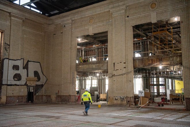 Workers walk through the atrium as construction continues at the Michigan Central Station, owned by Ford, in Detroit, January 11, 2022.
