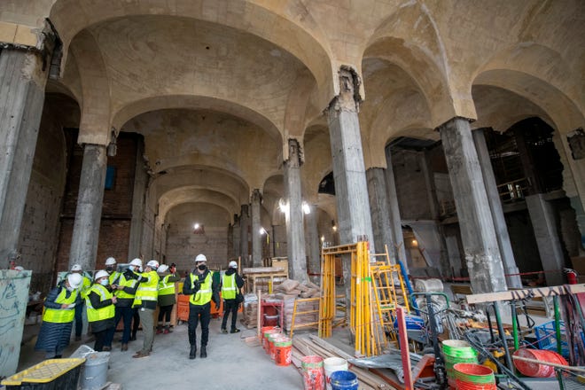 Journalists tour the ground floor as construction continues at the Michigan Central Station, owned by Ford, in Detroit, January 11, 2022.