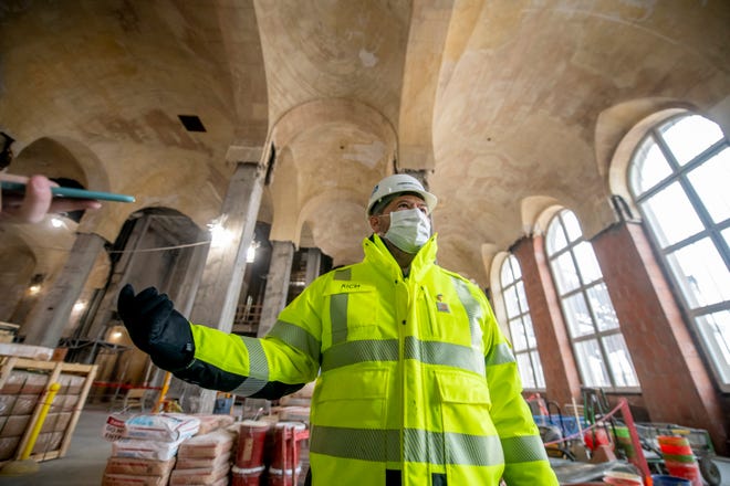 Construction manager Rich Bardelli stands inside the ground floor of the Michigan Central Station, owned by Ford, in Detroit, January 11, 2022.