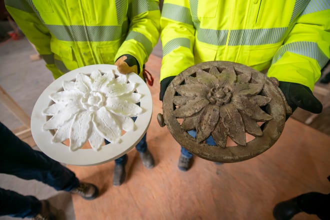 A cast iron rosette, at right, is compared with a new one 3d printed from resin from a digital scan of the original. The new ones weigh substantially less than the iron originals. The decorations will adorn the windows on the ground floor. Construction continues at the Michigan Central Station, owned by Ford, in Detroit, January 11, 2022.