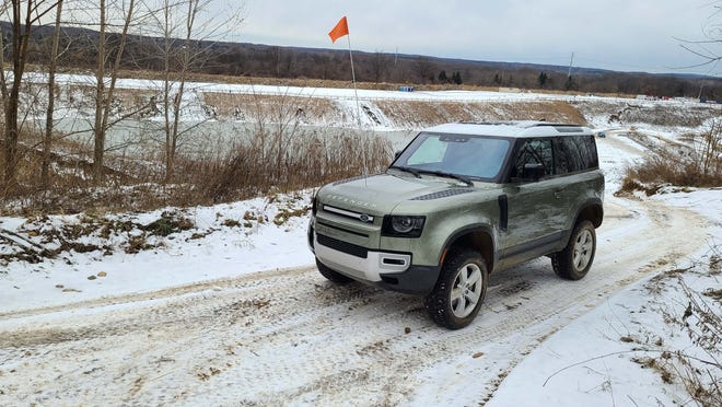 From atop the snowy hills of Holly Oaks, the 2021 Land Rover Defender 90 strikes a nice pose in Pangea Green.