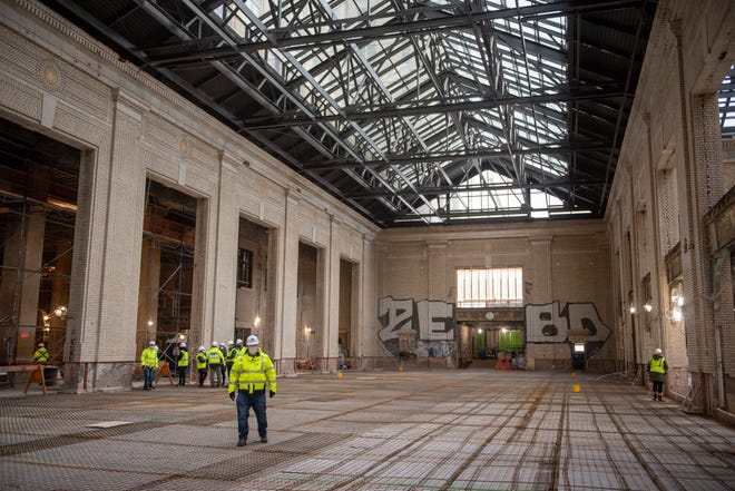 Journalists tour the atrium as construction continues at the Michigan Central Station, owned by Ford, in Detroit, January 11, 2022.