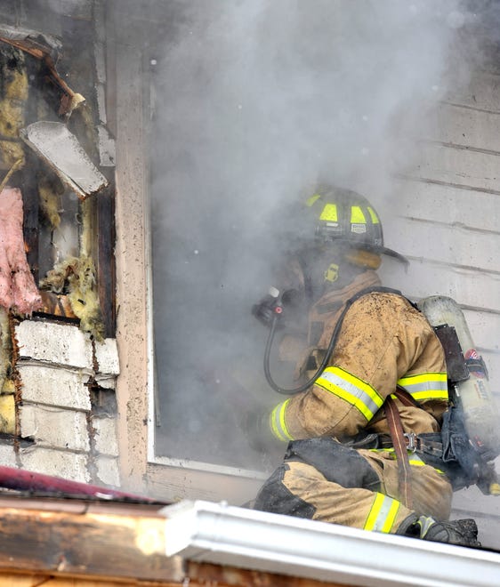 A firefighter battles the blaze on Friday, Jan. 14, 2022.