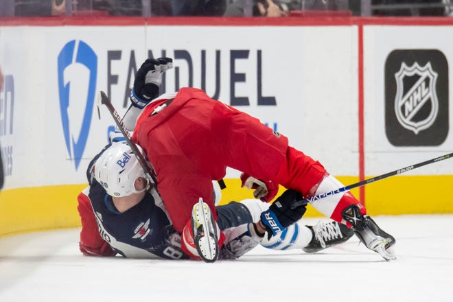 Detroit center Pius Suter and Winnipeg left wing Pierre-Luc Dubois get tangled up on the ice during the second period.