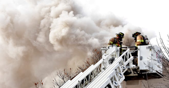 Firefighters battle the blaze from above on Friday, Jan. 14, 2022.