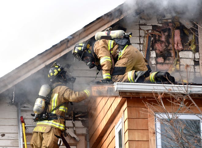 Firefighters talk to each other while battling the blaze on Friday, Jan. 14, 2022.