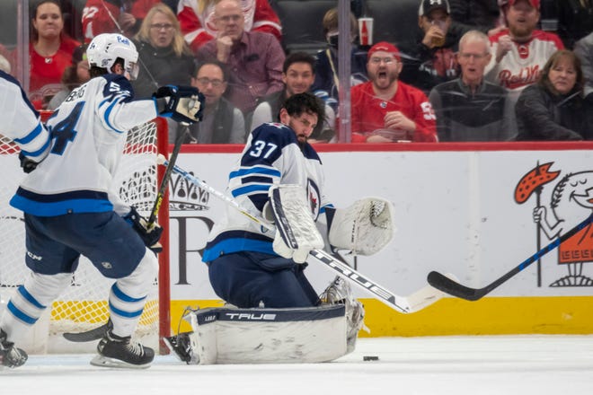 Winnipeg goaltender Connor Hellebuyck has his mask fall off during the second period.