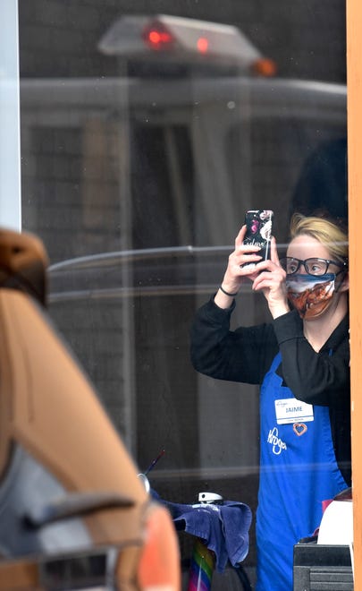 Jamie Bonneau shoots cell phone video, Friday, Jan. 14, 2022, from Elizabeth's Hair Salon where she gets her hair done every Friday.