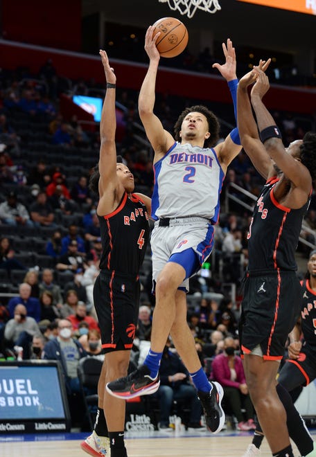 Detroit Pistons guard Cade Cunningham (2) shoots over Toronto Raptors forward Scottie Barnes (4) and Toronto Raptors forward OG Anunoby (3) in the first quarter. Cunningham had 18 points, 7 rebounds and 5 assists.