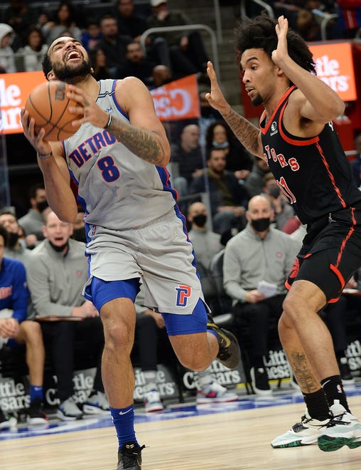 Detroit Pistons forward Trey Lyles (8) is fouled by Toronto Raptors forward Justin Champagnie (11) in the second quarter.