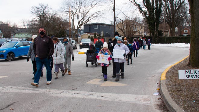 Walkers finish up the MLK freedom walk at the Royal Oak Middle School in Royal Oak, Michigan, on January 17, 2022.