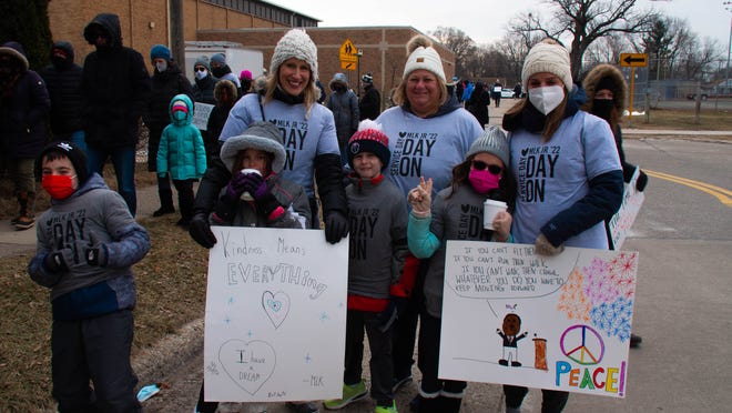 (The adults from left to right) Donna Sternicki, Rami Garrett and Emily Kaczander take their children to the Martin Luther King Jr. freedom walk that started at the Royal Oak Middle School in Royal Oak, Michigan, on Monday January 17, 2022.