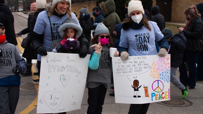 (The adults from left to right) Donna Sternicki and Emily Kaczander take their children to the Martin Luther King Jr. freedom walk that started at the Royal Oak Middle School in Royal Oak, Michigan, on Monday, January 17, 2022.