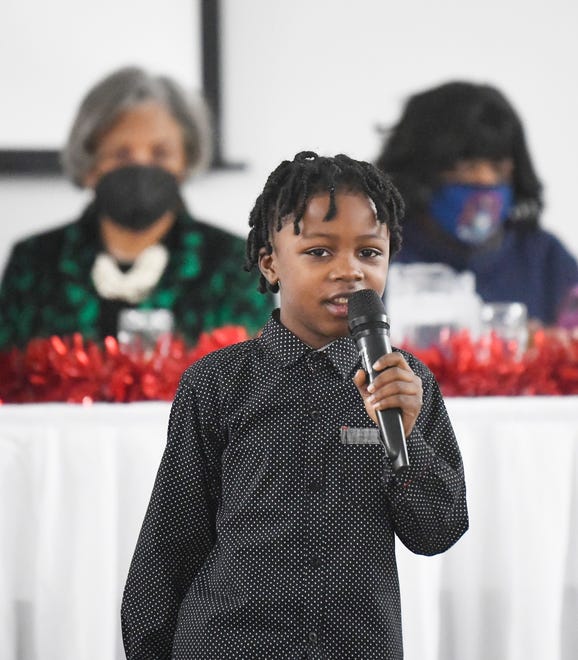 Second grader Rahim Foryoh, 7, recites the poem "Our Greatest Fear" by Marianne Williamson during the Rev. Dr. Martin Luther King Jr. 30th Annual Luncheon at St. George's Cultural Center in Pontiac, Michigan, on January 17, 2022.