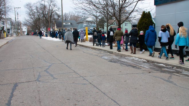 Walkers reach the last leg of the MLK freedom walk in Royal Oak, Michigan, on January 17, 2022.