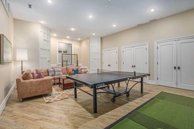 Downstairs, the lower level features 15-foot-high ceilings, an entertainment area with home theatre, a home golf simulator, two bedrooms, a full bathroom plus storage space, the utilities and access to the three-car garage.