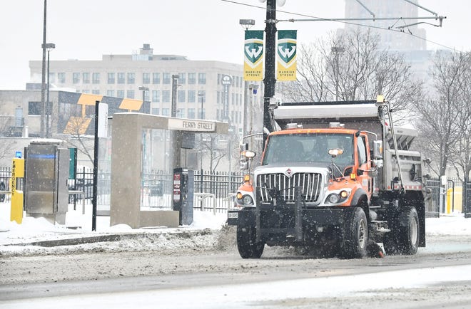 An MDOT salt truck plows on Woodward Avenue during a snowfall in Detroit on Jan. 24, 2022.