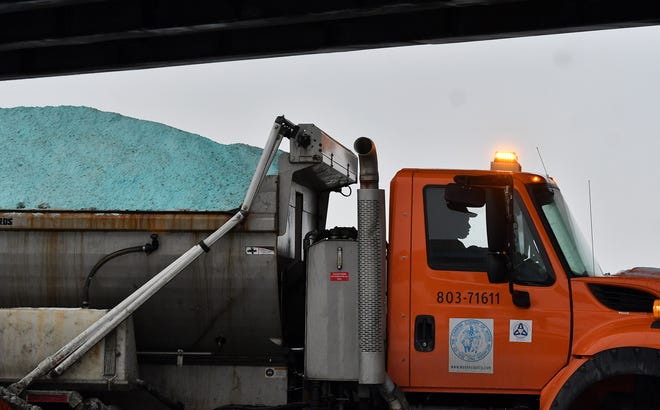 A Wayne County salt truck is amongst the traffic on I-94 near the I-75 interchange in Detroit on Jan. 24, 2022.