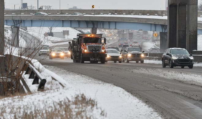 A Wayne County salt truck is amongst the traffic on I-94 near the I-75 interchange in Detroit on Jan. 24, 2022.