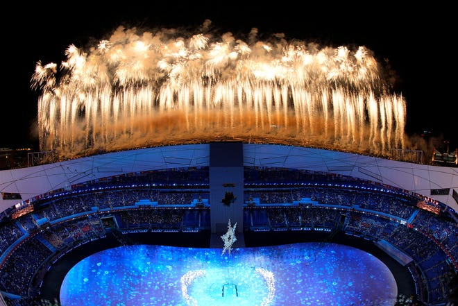 Fireworks light up the sky over Olympic Stadium during the opening ceremony of the 2022 Winter Olympics.