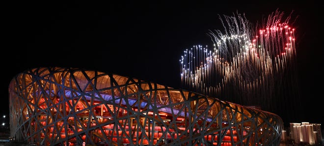 A panoramic view of fireworks in the shape of the Olympic Rings lighting up the sky above the National Stadium, known as the Bird's Nest, during the opening ceremony of the Beijing 2022 Winter Olympic Games in Beijing, on February 4, 2022.