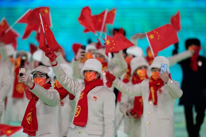The team from China arrives during the opening ceremony of the 2022 Winter Olympics.