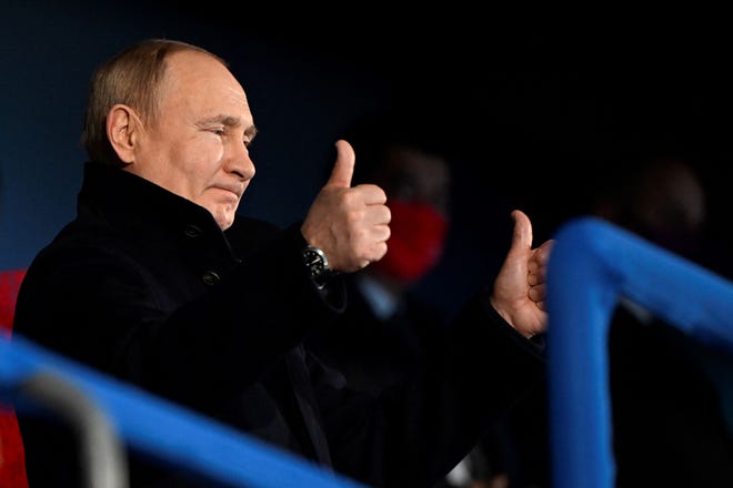 Russia's President Vladimir Putin gestures during the opening ceremony of the Beijing 2022 Winter Olympic Games, at the National Stadium, known as the Bird's Nest, in Beijing, on February 4, 2022.