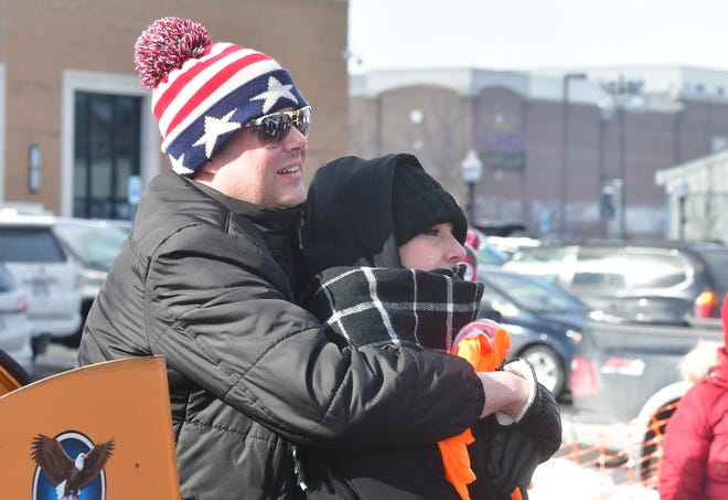 Steve Pokrefky hugs MJ as they try to stay warm during Winter Blast in Royal Oak on Saturday, February 19, 2021.