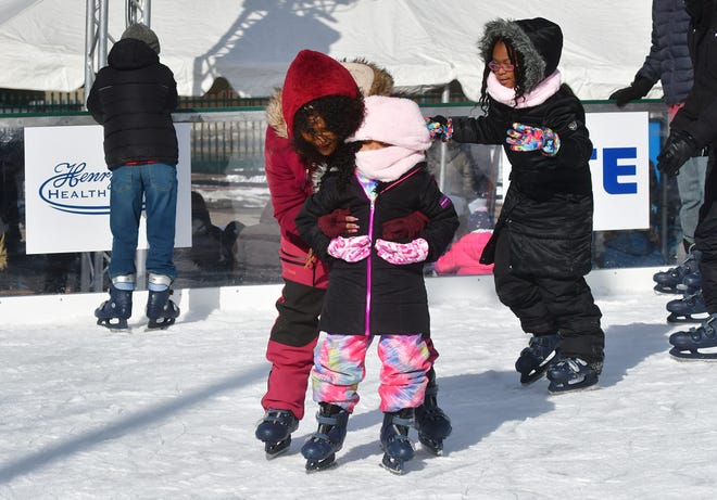 Kiara  Powell assists her daughter Layla as they slowly move around the M3 Skating Rink during Winter Blast in Royal Oak on Saturday, February 19, 2021.