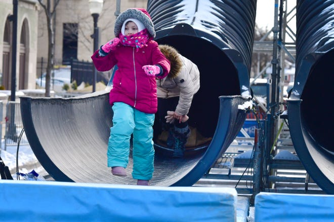 Ava Romano of Brighton leaps out of the tunnel slide during Winter Blast in Royal Oak on Saturday, February 19, 2021.