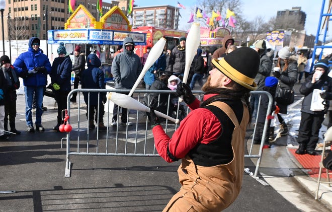 Detroit Circus performer Scott Vasnsice entertains a crowd with his juggling during Winter Blast in Royal Oak on Saturday, February 19, 2021.